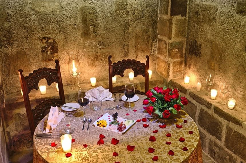 Romantic dinner table with red roses décor & candles in The Kitchen at Pensativo House Hotel