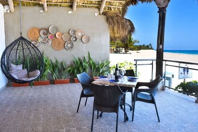 Hanging rattan & dining table setup at Blue JackTar Hotel