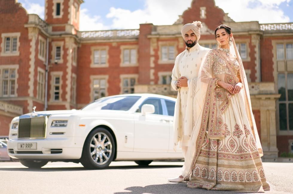 bride and groom standing outside of easthampstead park in berkshire