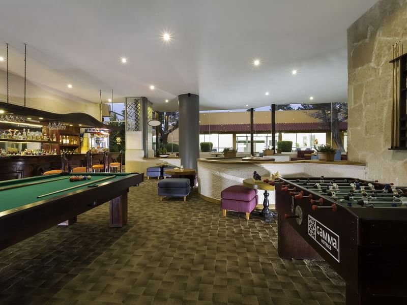 Interior of the lobby area with a foosball & pool table at Gamma Pachuca