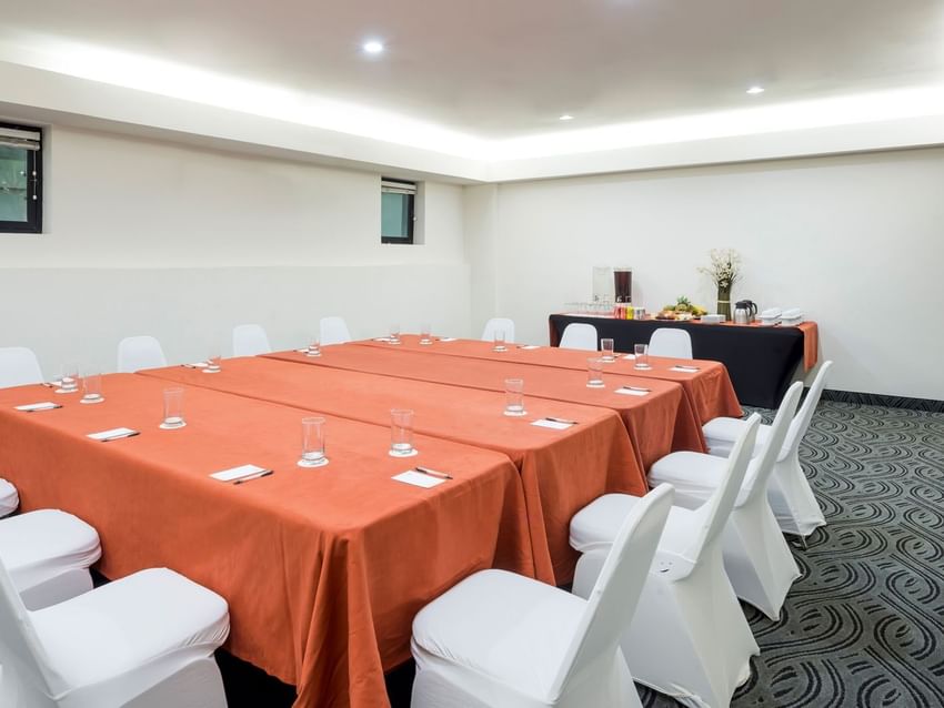 Setup table with a notepad and a water glass beside the buffet table in Budapest at Real Inn Mexicali