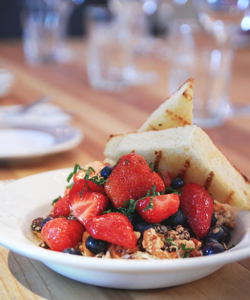 Toasted bread slices served with fresh berries in Louise Taverne & Wine bar at Hotel Port Royal