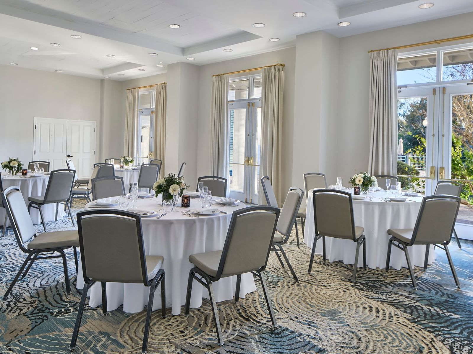 Orlando meeting venues of Sabal Ballroom at the Inn at Celebration, set with banquets and chairs near glass patio doors