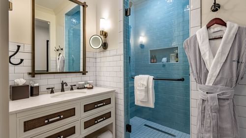 Bathroom vanity & shower area in Golf View King Room at Camp Creek Inn