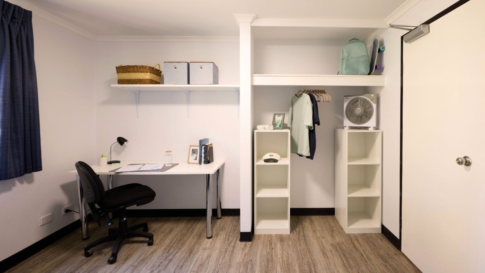 Spacious room with desk, shelf, fan, and wardrobe at UniLodge at Curtin University - Erica Underwood House.