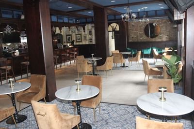 Dining tables arranged in Mingles Bar & Lounge at Courtleigh Hotel & Suites