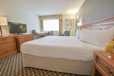 King bed with TV on dresser.
