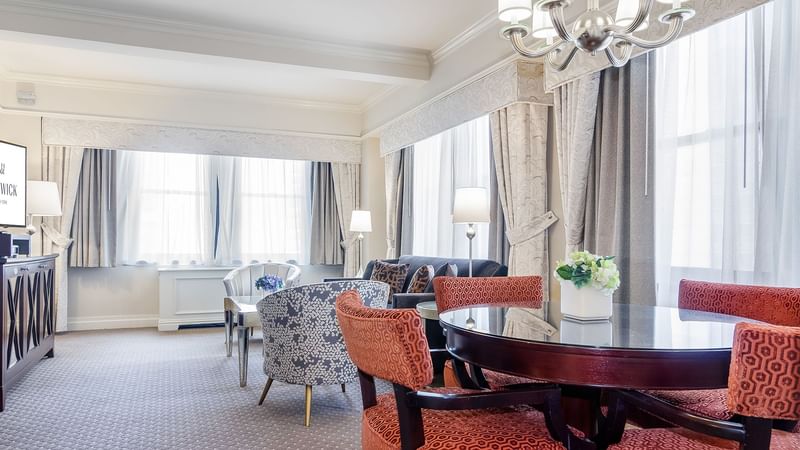 Dining area and lounge area in The Avenue One Bedroom Suite at Warwick New York