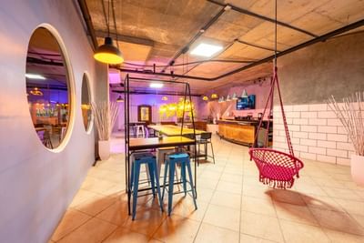 Dining area with eclectic furniture and warm ambient lighting at Panama hotel restaurant