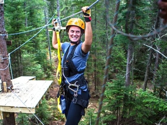 Close-up of a woman riding a Zipline near High Peaks Resort