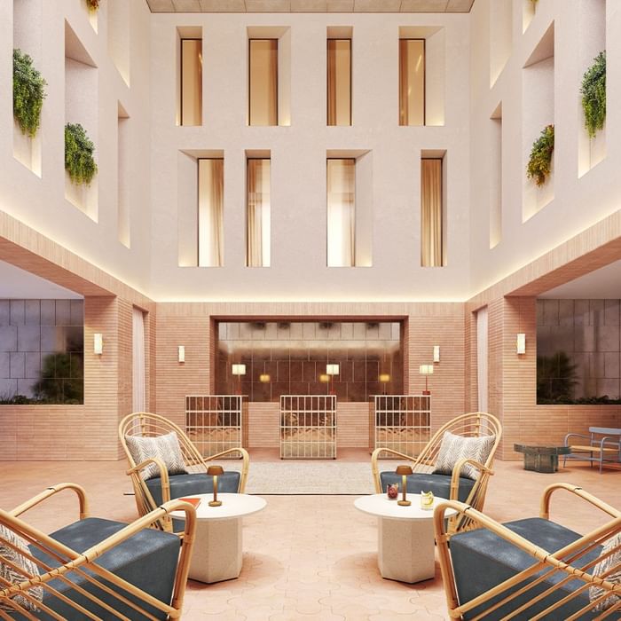 A modern interior design with bamboo chairs, tables, and decorative plants on the walls.