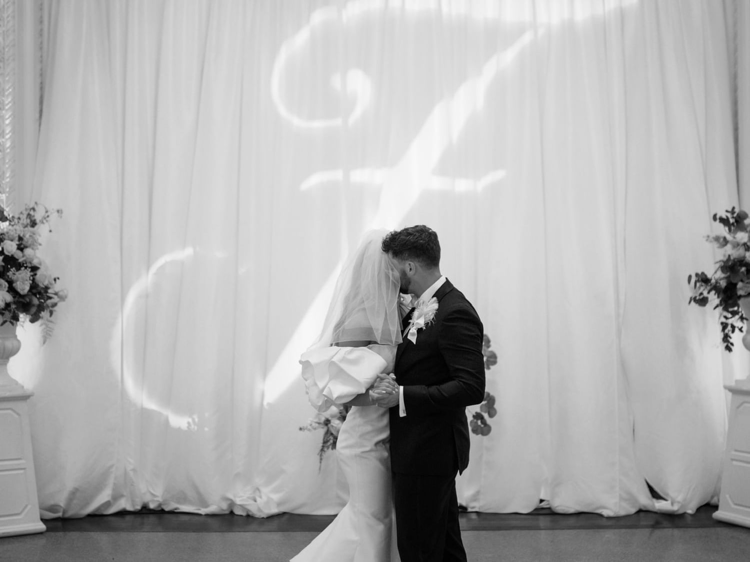 Bride & groom kissing in reception at The Mayo Hotel