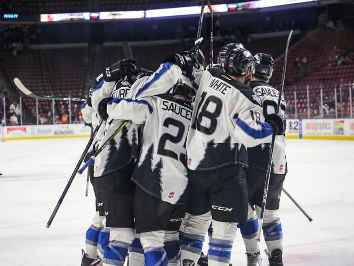 A hockey team cheering in a court near Hotel 43