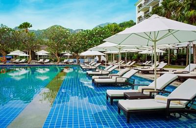 An infinity pool with sunbeds at The Danna Langkawi