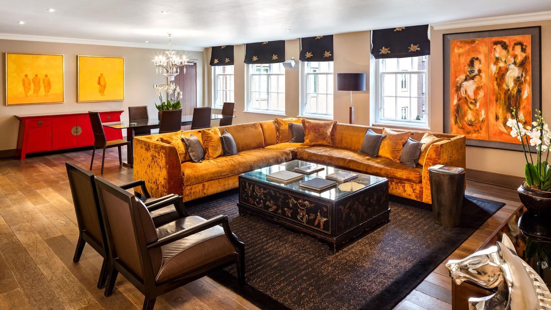 Elegant living room in the Amber Suite at The May Fair Hotel London, featuring a sectional sofa and a coffee table