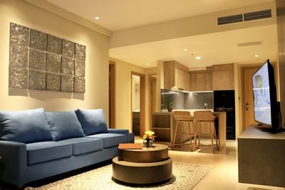 Blue sofa & TV in One Bedroom Apartment at Vasa Hotel Surabaya