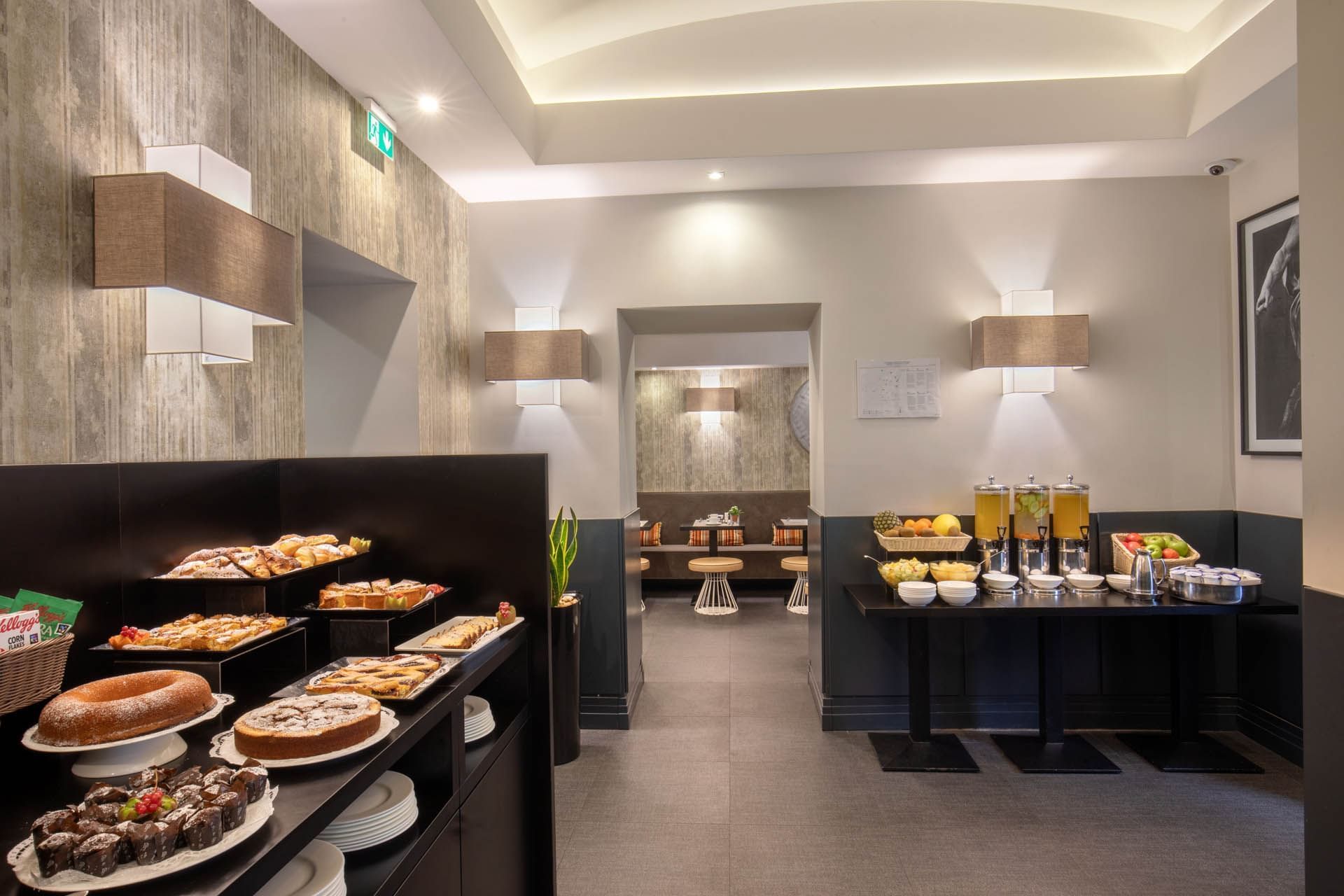 Breakfast room featuring a buffet table with pastries and drinks in a stylish, well-lit setting at The Republic Hotel