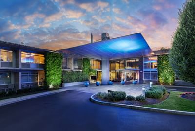 The J House Greenwich entrance with a blue-lit canopy, boutique hotel near i95 and train to NYC, Greenwich