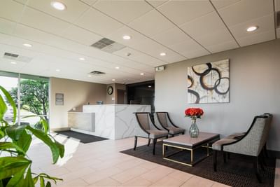 Lobby lounge area with front desk & seating area at Garden Executive Hotel, one of the best hotels in South Plainfield, NJ