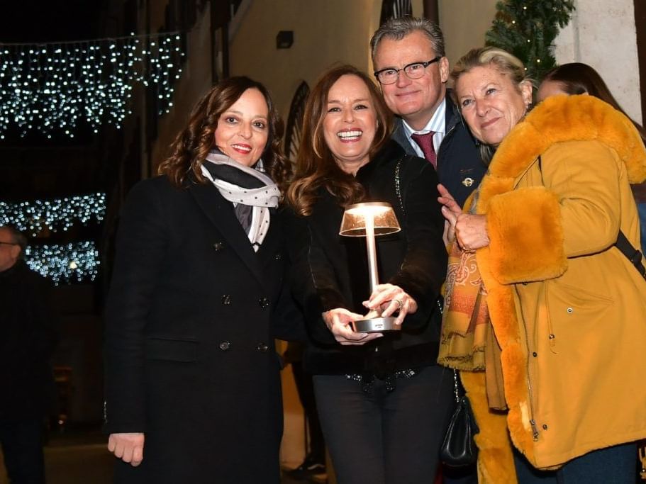 Four people posing for a photo at The traditional Christmas party of EMME Restaurant