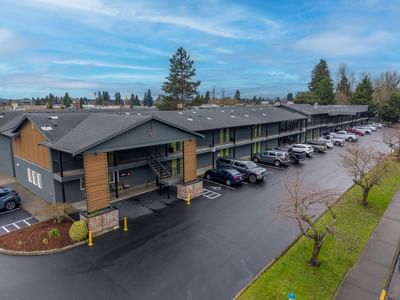 Aerial view of The Varsity North with a clean parking lot under a partly cloudy sky, one of the best hotels in Centralia, WA