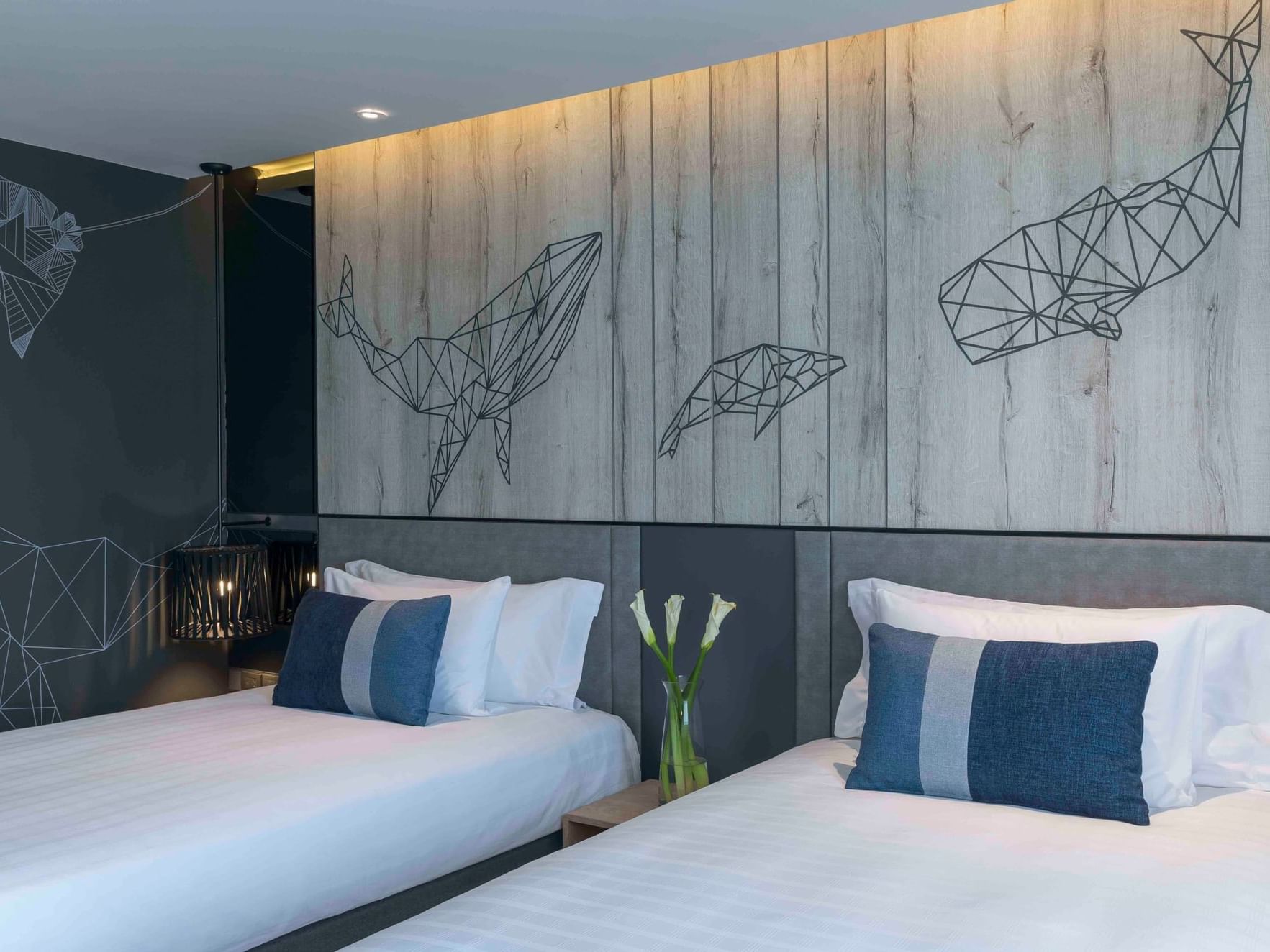 Twin beds in Deluxe room with murals at U Hotels & Resorts