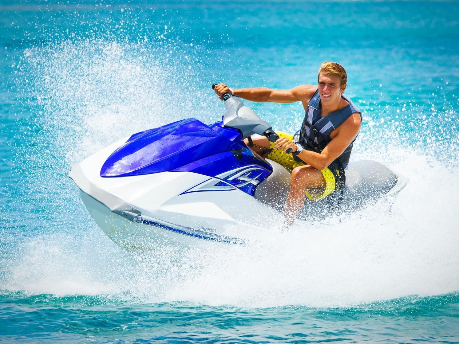 A man enjoying a thrilling jet ski ride near Costa Beach Resort