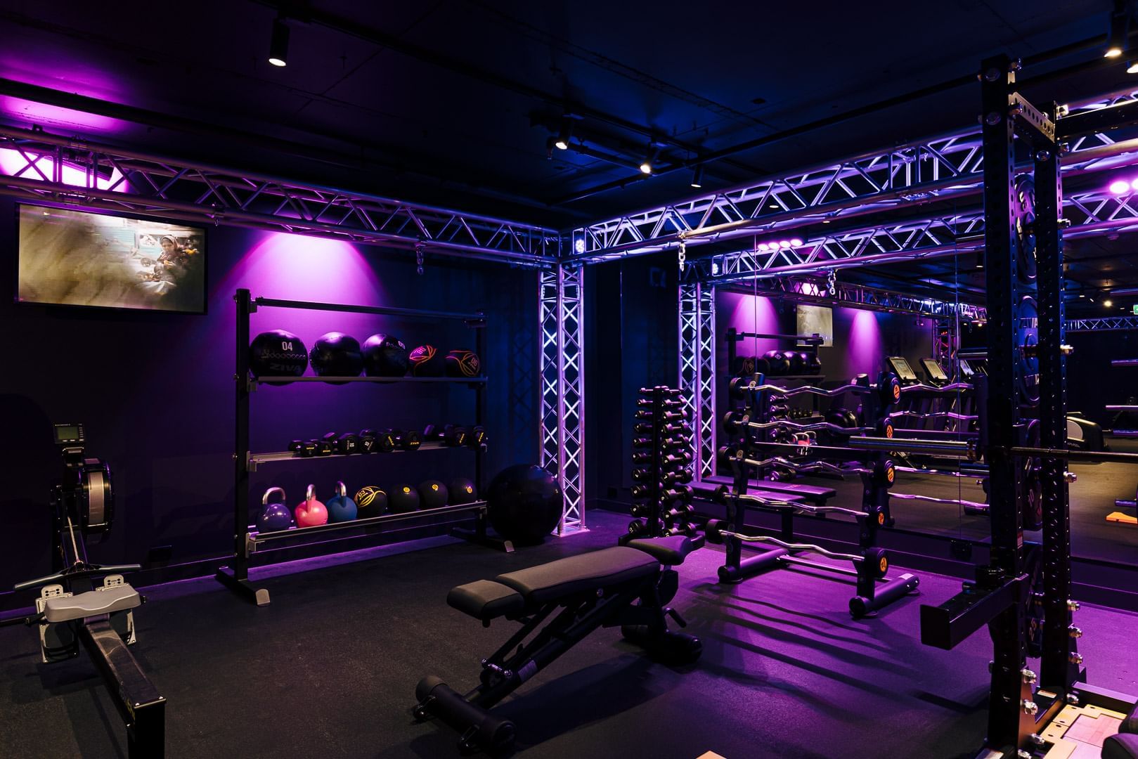 Gym interior with purple lights at Pullman Melbourne CBD
