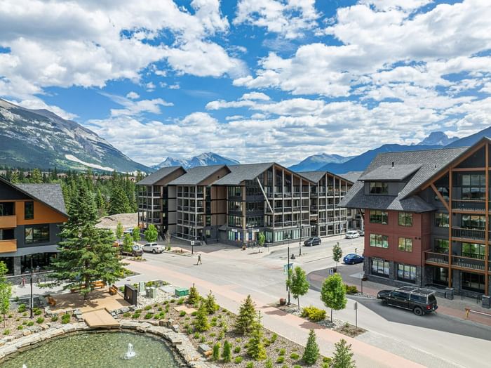 Timberstone Mountain Lodge with distant peaks under a blue sky at Spring Creek Vacation Homes Canmore