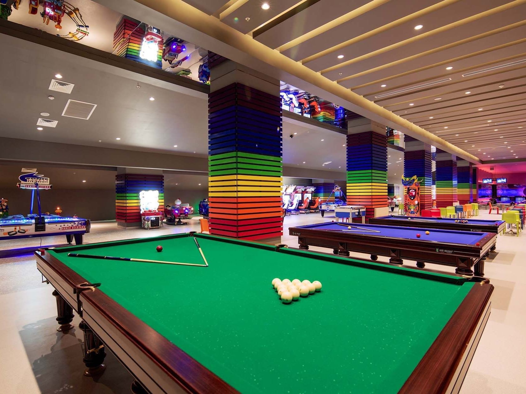 Pool boards with cue sticks and pool balls in Game Center near Titanic Deluxe Golf Belek
