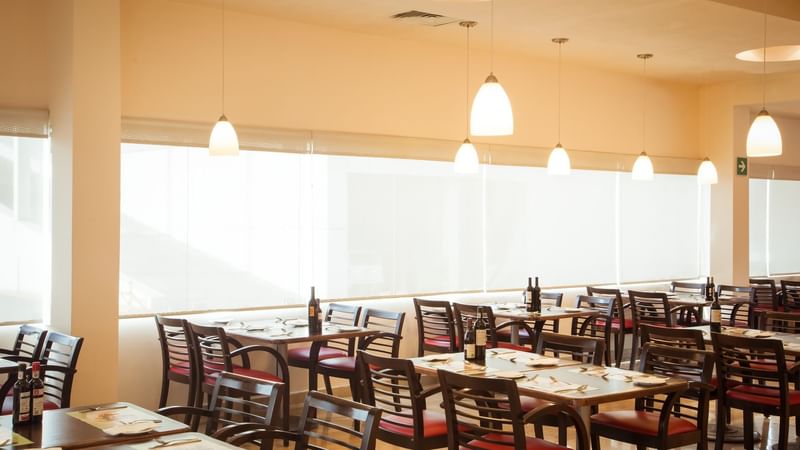 Dining tables set-up in the restaurant at Fiesta Inn Hotels