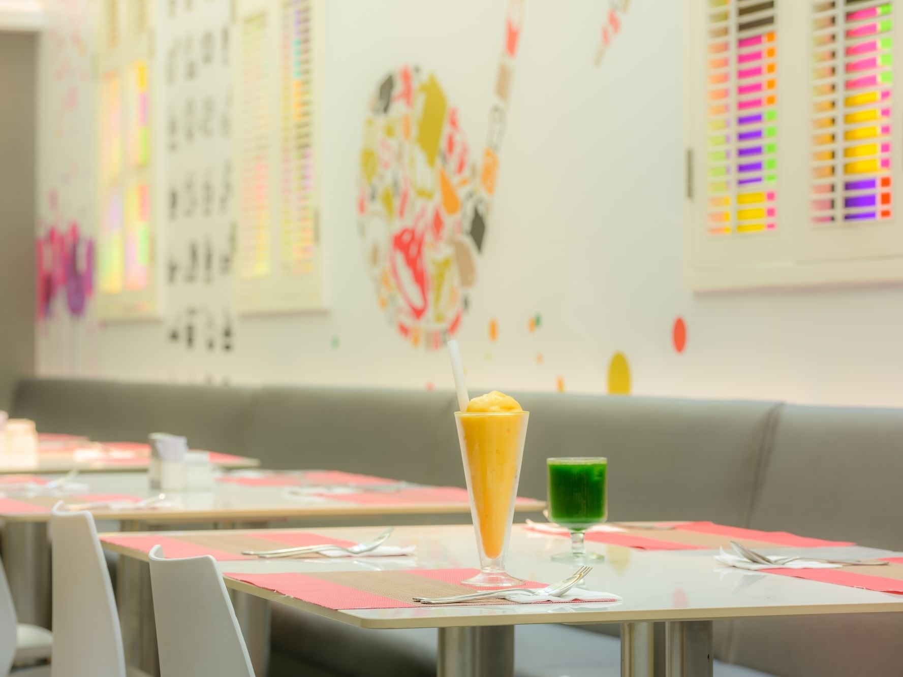 Bright dining area with a fresh orange smoothie at Inn Café, featured among the top restaurants in Macau, China