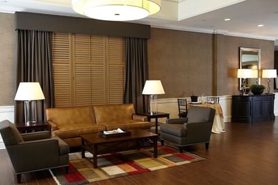 Cozy brown leather couch in the lobby area at Ethan Allen Hotel