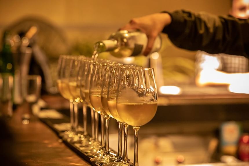 Close-up of pouring wine into glasses at South Beach Hotel