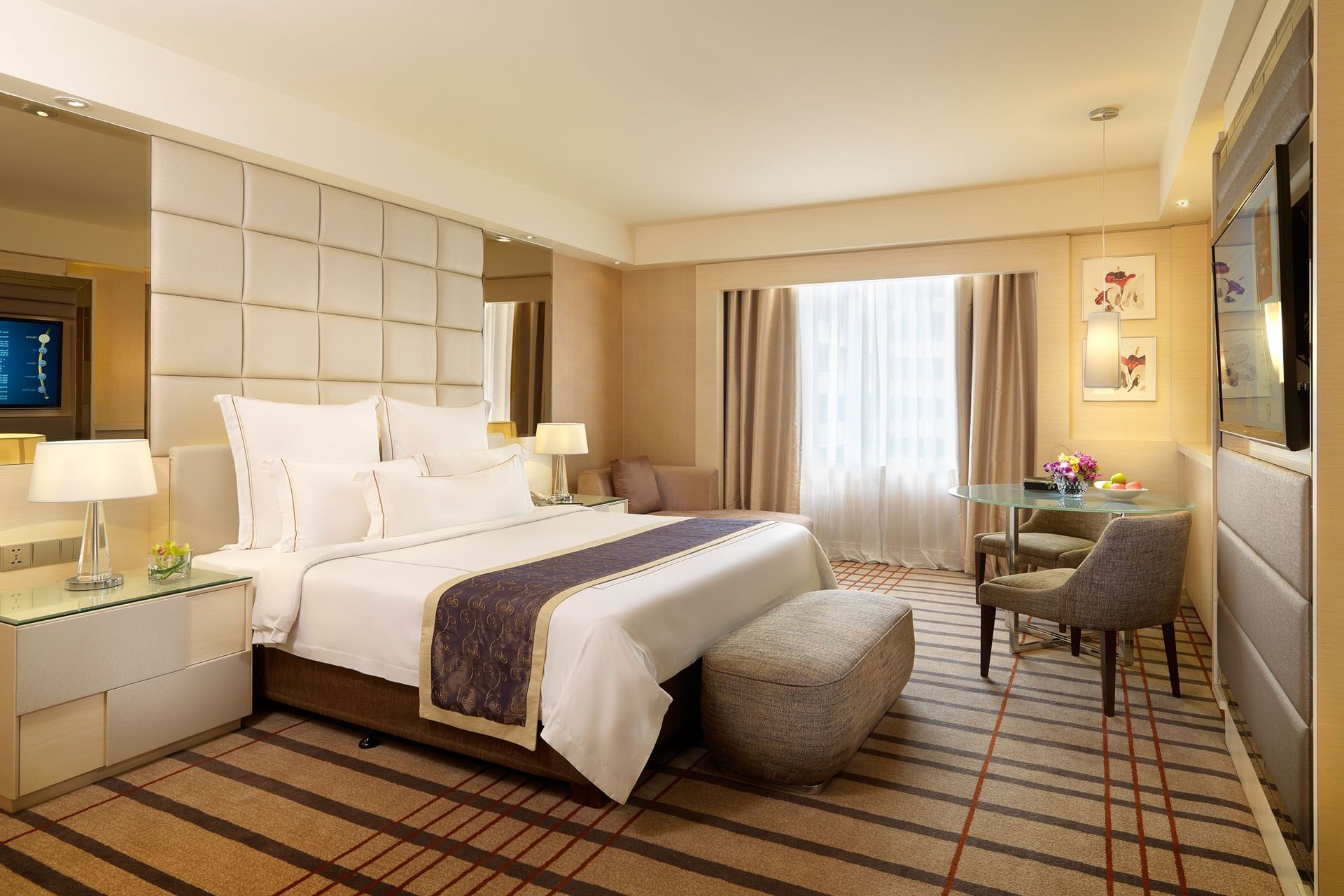 TV stand & work desk facing a bed in Executive Deluxe with carpeted floors, A One World Hotel room