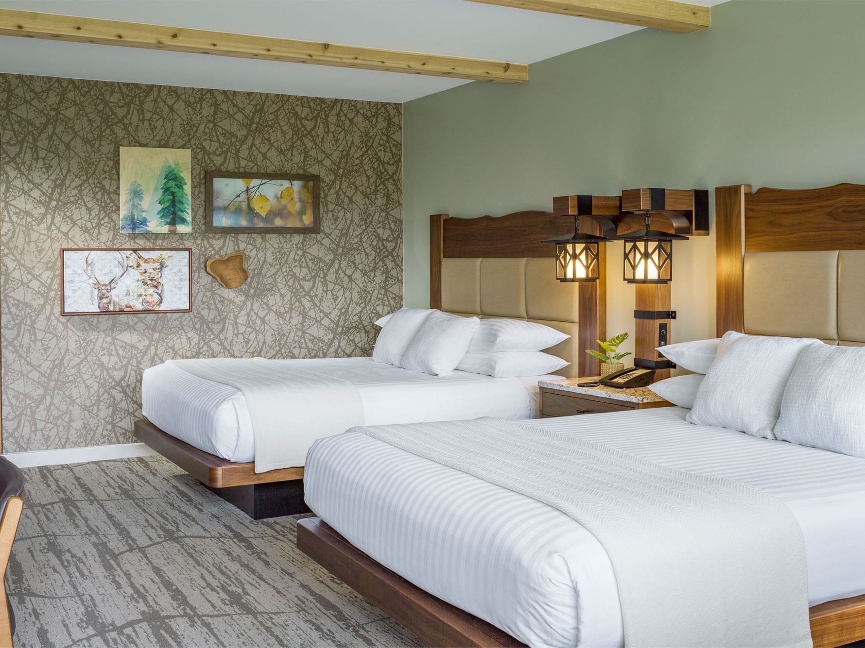 Signature Double Queen Room with 2 double beds & a chair at High Peaks Resort