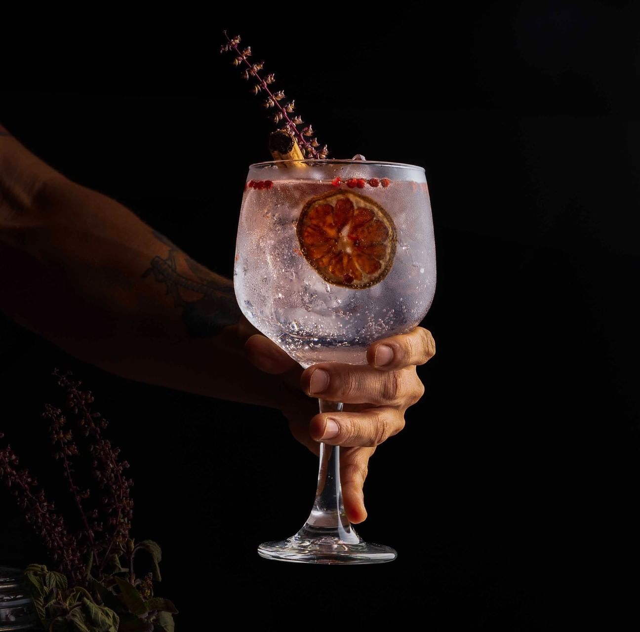 Refreshing gin and tonic garnished with a dried citrus slice and botanicals served at Cala Luna Boutique Hotel