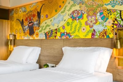 Colorful wallpapers & comfy beds in Superior Room at Eastin Ashta Resort Canggu