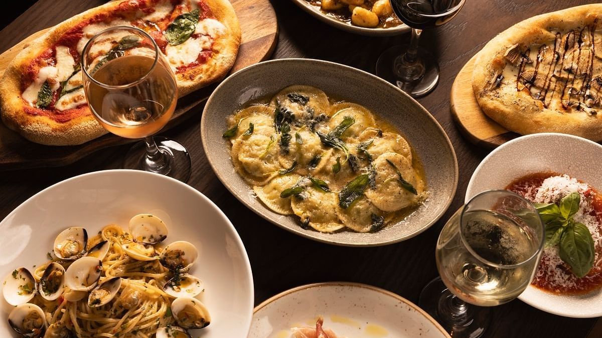 Italian feast with pasta, pizzas, ravioli and wine served in Di Francesco Cucina at Crown Hotel Melbourne