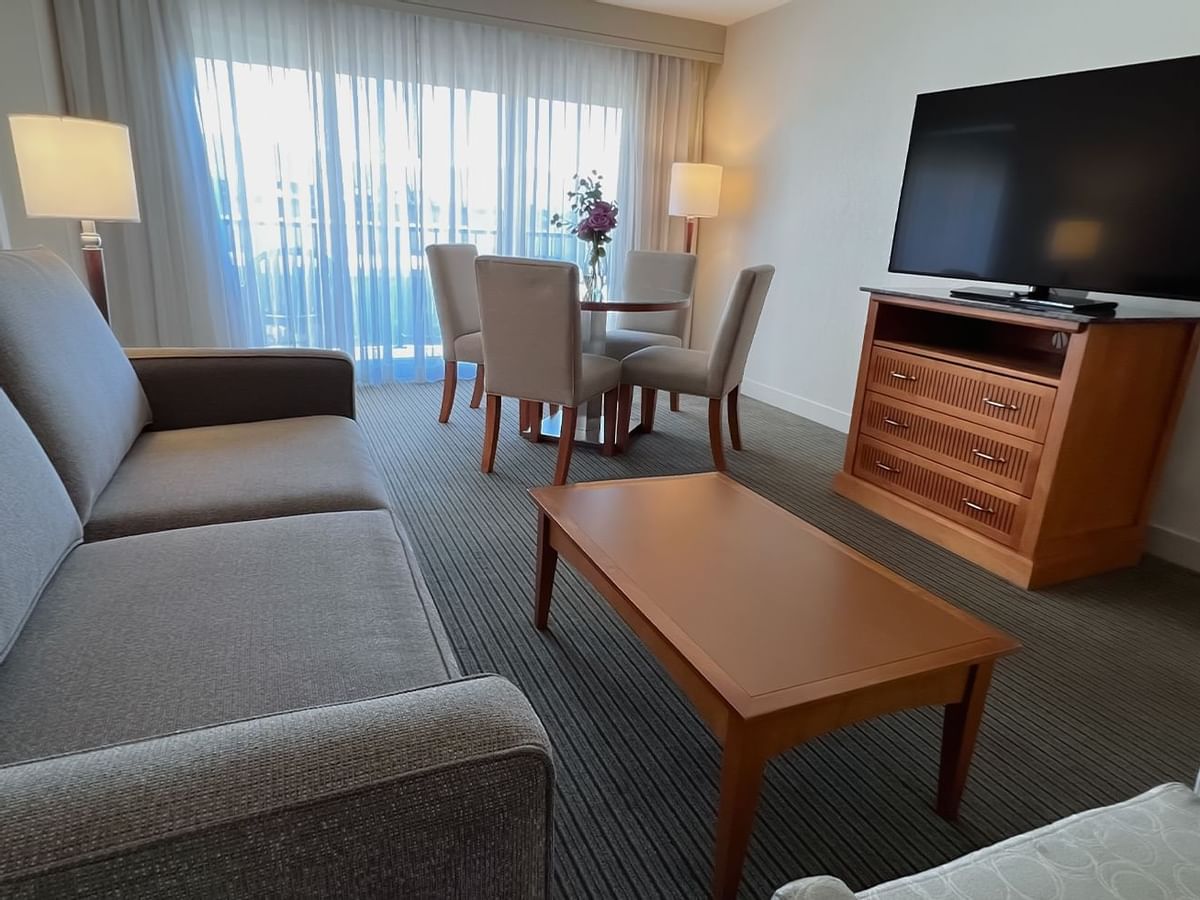 Guest room with couch, table, tv, dining table and chair