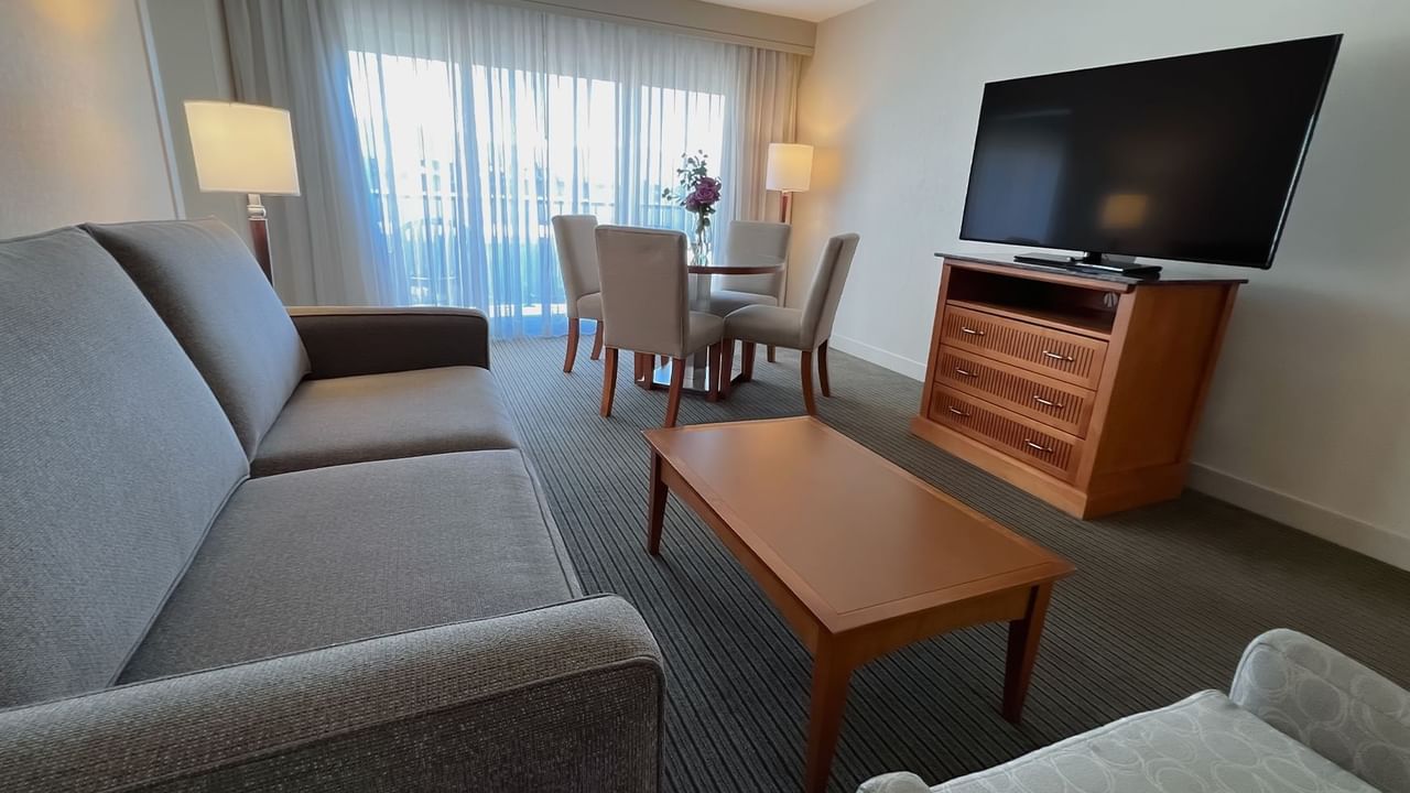 Guest room with couch, table, tv, dining table and chair