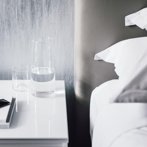 Glass of water near the bed at Como Melbourne