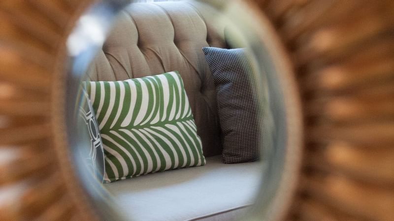 Mirror reflecting a couch in Marion Suite at Warwick New York