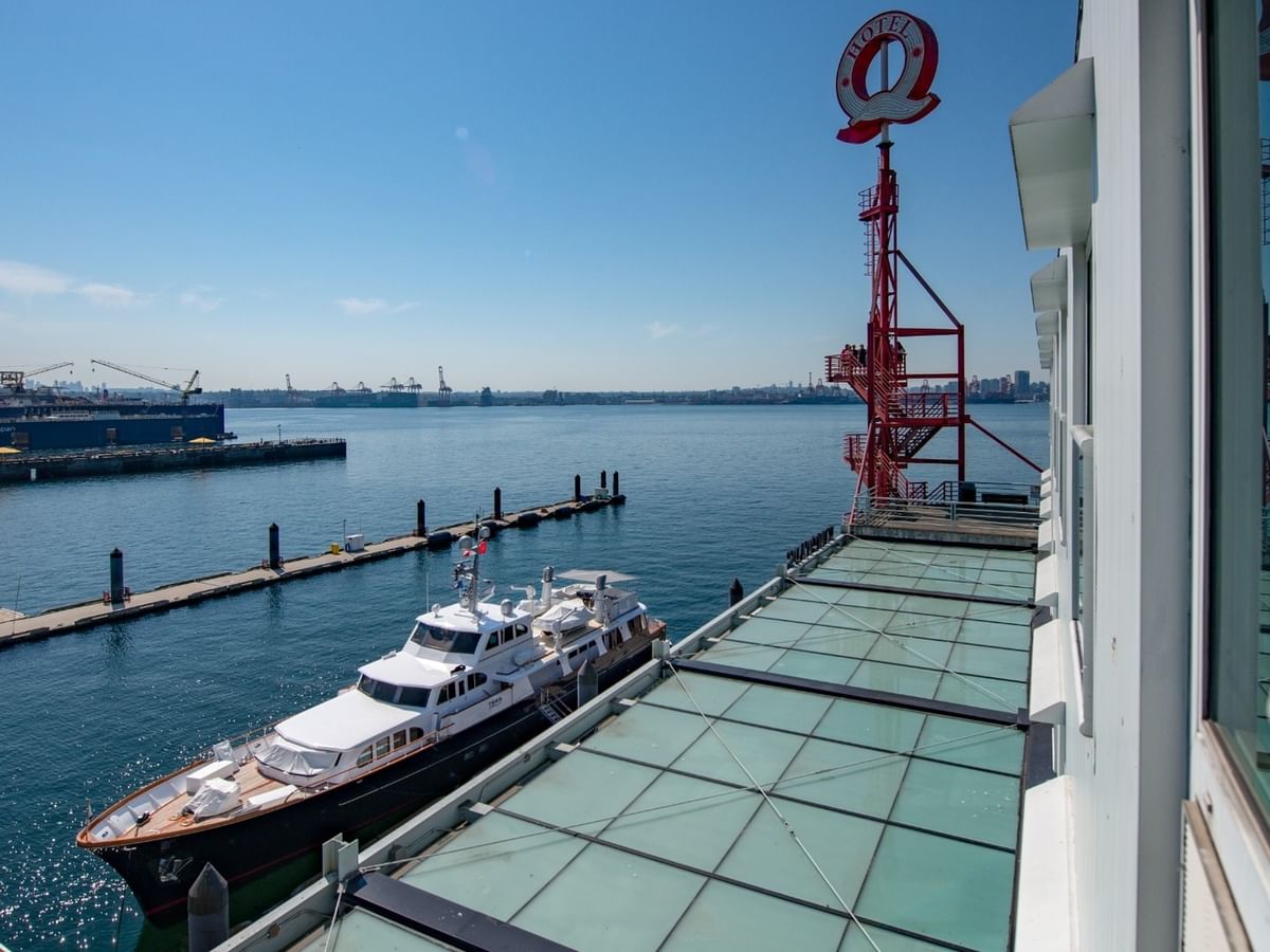 View from a window showing a boat and a dock at Coast Lonsdale Quay Hotel