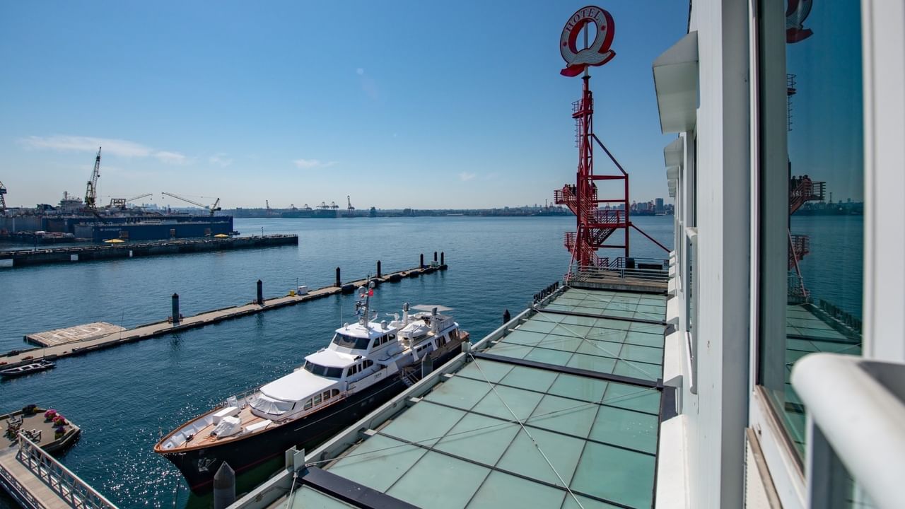 View from a window showing a boat and a dock at Coast Lonsdale Quay Hotel