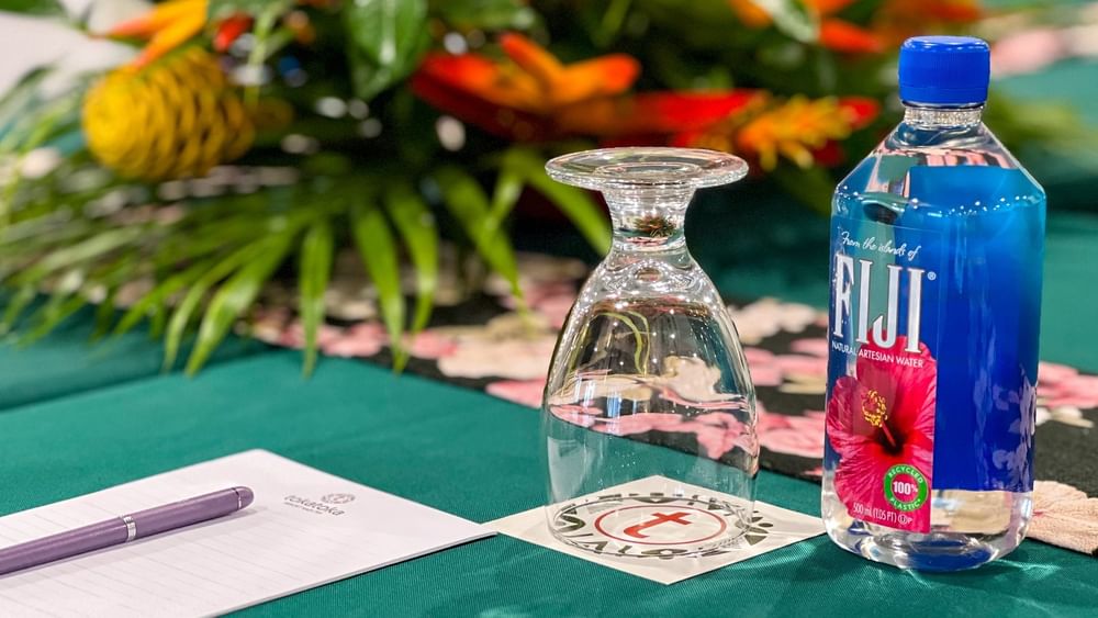 Glassware, water bottle, and notepad on green table at Talei Meeting Room in Tokatoka Resort Nadi.