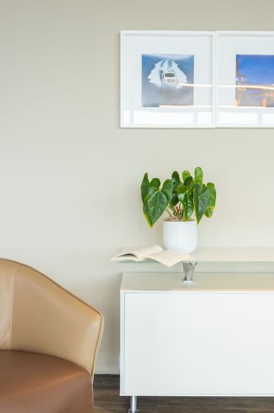 A book & a plant kept on a cabinet at Costa Beach Resort