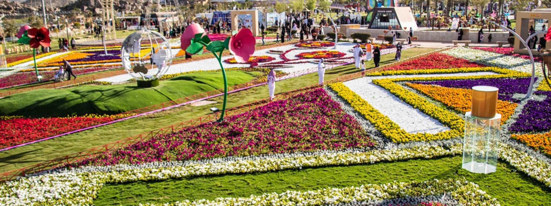 Walkaway path with arranged flower beds in Arruddaf Park near Warwick Taif Hotel