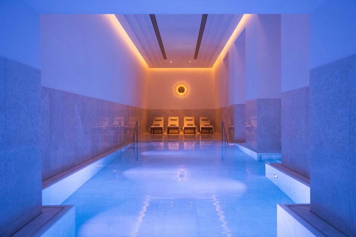 Indoor swimming pool with arranged pool beds at Almanac Palais Vienna