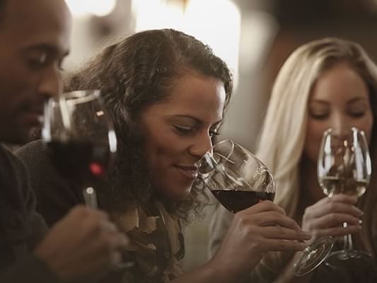 Closeup of a group tasting red wine at Originals Hotels